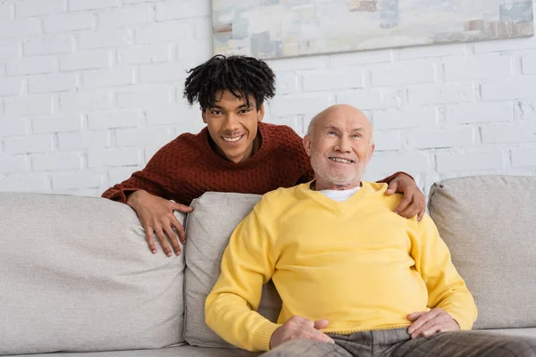 Positive African American Grandson Hugging Grandfather Living Room — 스톡 사진