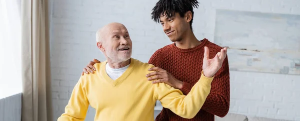 Smiling African American Grandson Hugging Grandparent Home Banner — ストック写真