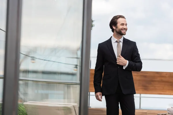 Young Groom Smiling While Adjusting Jacket Terrace — 스톡 사진