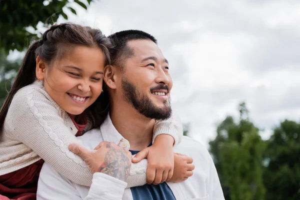 Cheerful Asian Daughter Hugging Tattooed Father Park — Fotografie, imagine de stoc