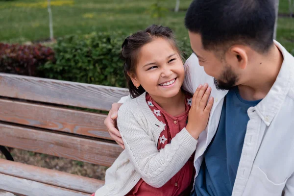 Cheerful Asian Girl Hugging Bearded Father Bench Park — Stok fotoğraf