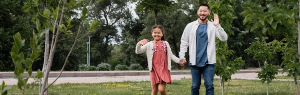 Cheerful Asian Family Waving Hands Camera Lawn Park Banner — Foto de Stock