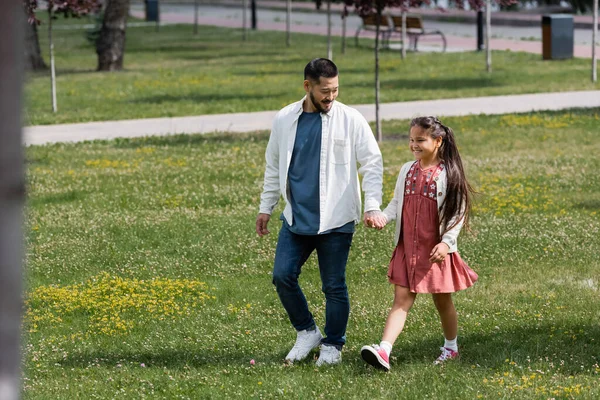 Positive Asian Parent Kid Holding Hands While Walking Park — ストック写真