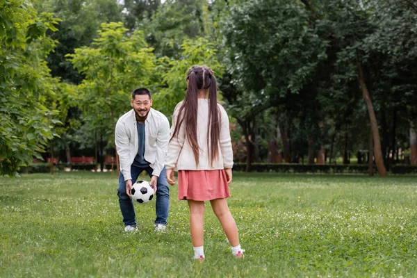 Smiling Asian Dad Holding Football Daughter Summer Park — Foto de Stock