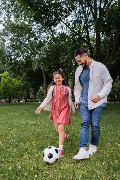 Smiling Asian Parent Girl Playing Football Field Park — Stockfoto