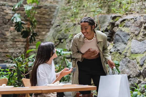 Happy African American Woman Holding Shopping Bags Friend Coffee Outdoor — Stok fotoğraf