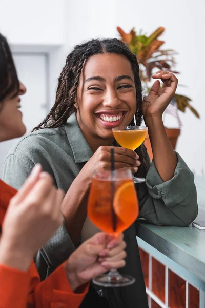 Positive African American Woman Holding Cocktail Blurred Friend Cafe — Zdjęcie stockowe