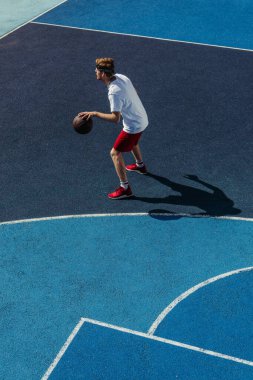 high angle view of young basketball player training on modern court
