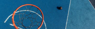 top view of basketball ring and ball on modern court, banner