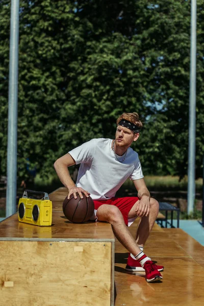Full Length Man Red Sneakers Sitting Stadium Boombox — Stok fotoğraf