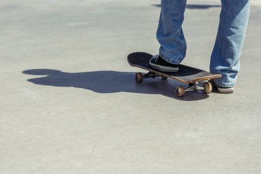 cropped view of man in gumshoes on skate outdoors