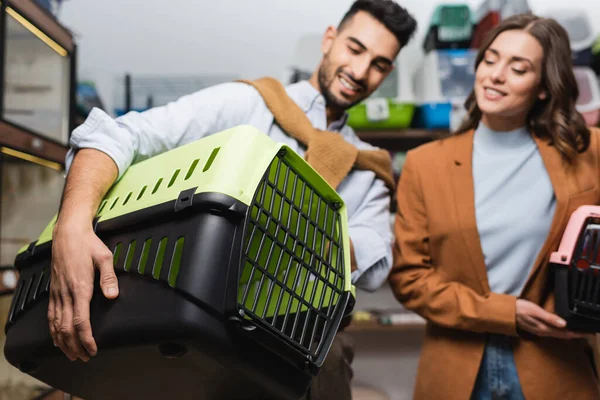 Blurred Interracial Couple Holding Animal Cages Pet Shop — Fotografia de Stock