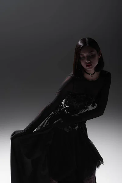 Young Asian Woman Black Gothic Dress Holding Lace Skirt While — Zdjęcie stockowe