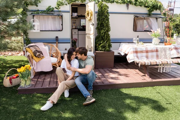 Positive Man Hugging Girlfriend Camper Van Outdoors — стоковое фото