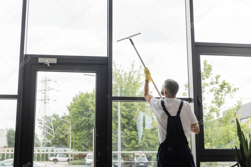 Window cleaning in high-rise buildings, houses with a brush