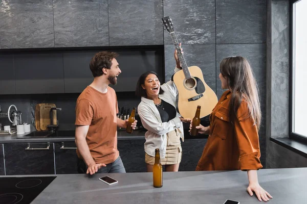 Amazed Racial Woman Holding Acoustic Guitar Cheerful Friends Bottles Beer — Stock Photo, Image