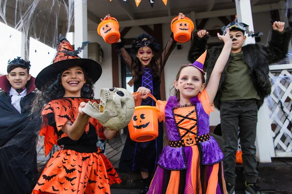 Excited Multicultural Friends Halloween Costumes Holding Trick Treat Buckets House — Stock Photo, Image