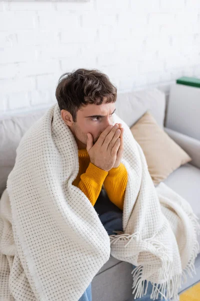Young Man Covered Blanket Sitting Sofa Warming Hands Living Room — Stock Photo, Image