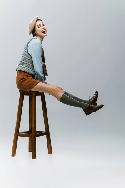 Full Length Amazed Young Woman Beret Autumnal Clothes Sitting Wooden — Stock Photo, Image