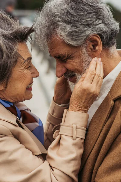 Portrait Cheerful Elderly Woman Hugging Bearded Husband Beige Coat — Stock Photo, Image