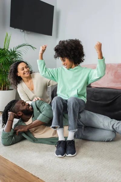 Cheerful African American Preteen Girl Sitting Hip Father Showing Power — Stock Photo, Image