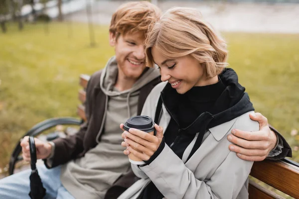 Happy Young Man Coat Looking Blonde Girlfriend Holding Takeaway Drink — Stock Photo, Image