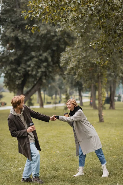 Full Length Happy Young Man Coat Holding Paper Cup Pulling — Stock Photo, Image