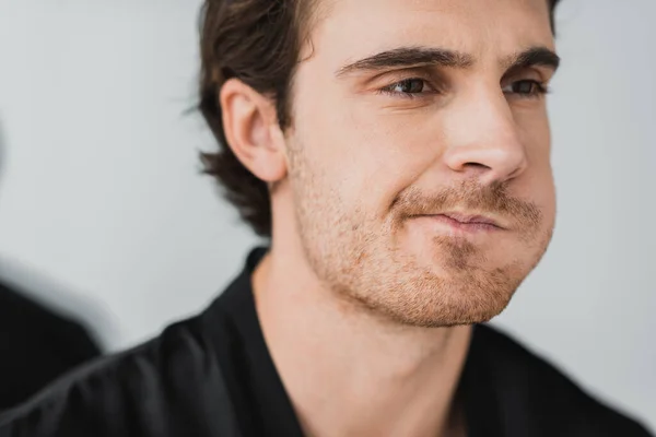 Young man rinsing mouth and looking away at home — Stock Photo