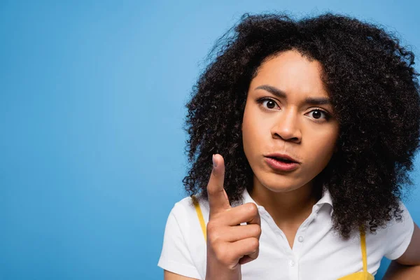 Wütende Afroamerikanerin blickt in die Kamera und zeigt mit dem Finger isoliert auf blau — Stockfoto