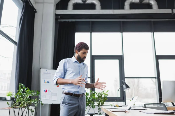 African american businessman talking during video call on laptop in office — Stock Photo