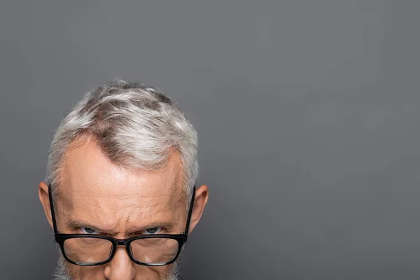 Cropped view of bearded middle aged businessman in glasses isolated on grey — Stock Photo