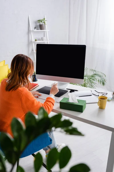 Back view of designer working at graphic tablet and computer monitor at home — Stock Photo