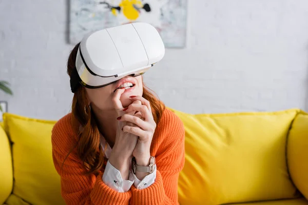 Worried woman with clenched hands gaming in vr headset at home — Stock Photo