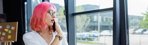 Gerente perforado con el pelo rosa hablando en el teléfono celular, pancarta - foto de stock