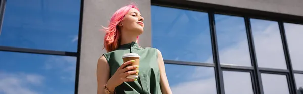 Sunshine on face of pleased woman with pink hair holding paper cup outside, banner — Stock Photo