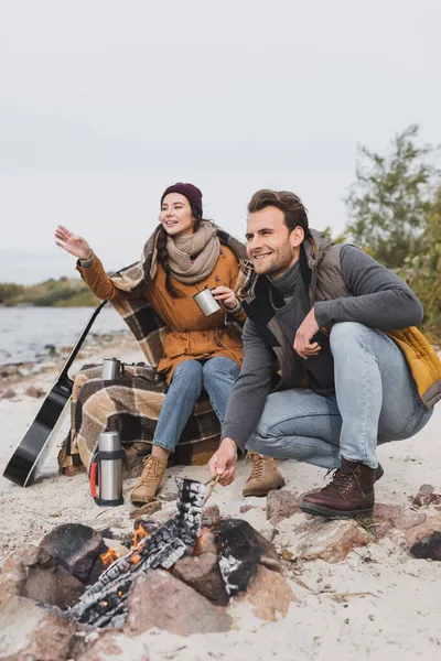 Woman pointing with hand during halt in autumn walk with boyfriend — Stock Photo