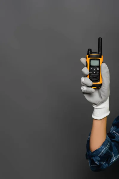 Cropped view of builder in glove holding walkie talkie isolated on grey — Stock Photo