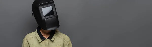 Jeune soudeuse en masque avec visière isolée sur gris, bannière — Photo de stock