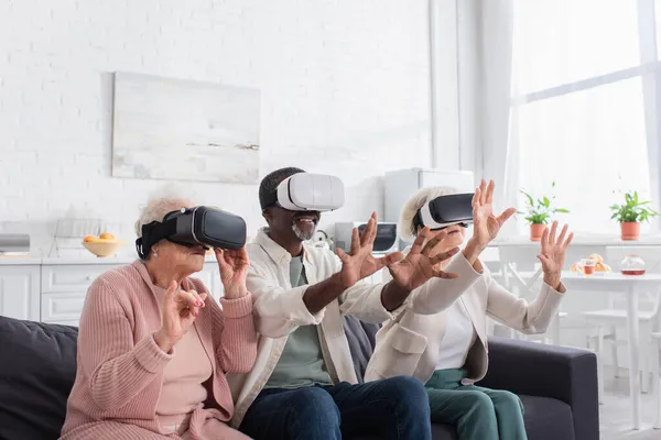 Multiethnic people gaming in vr headsets in nursing home — Stock Photo
