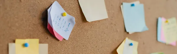 Colorful sticky notes on board in office, banner — Stock Photo