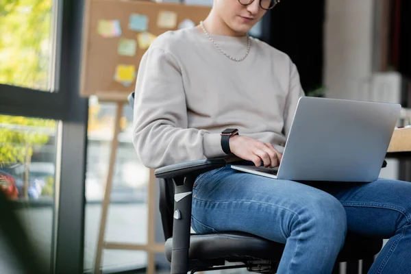 Cropped view of businessman using laptop in office — Stock Photo