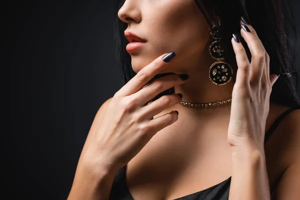 Cropped view of seductive woman in accessories isolated on black — Stock Photo
