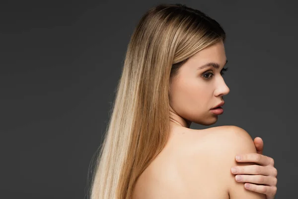 Sensual woman with bare shoulder and perfect skin posing isolated on grey — Stock Photo