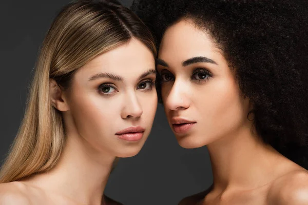 Pretty interracial women with clean skin and natural makeup isolated on grey — Stock Photo