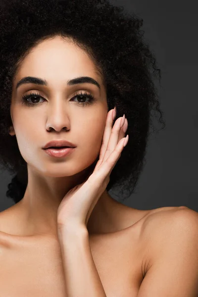 Close up view of african american woman touching perfect face isolated on grey — Stock Photo