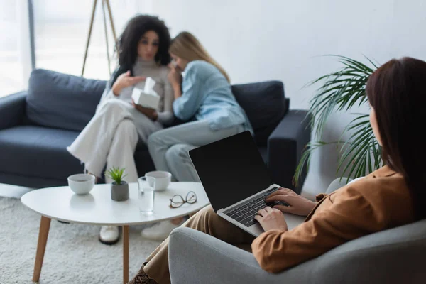 Blurred interracial lesbian couple with relationship difficulties having psychological consultation — Stock Photo