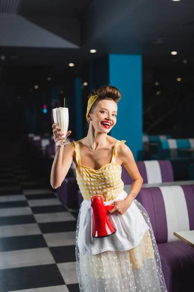 Happy pin up waitress holding megaphone and milkshake — Stock Photo