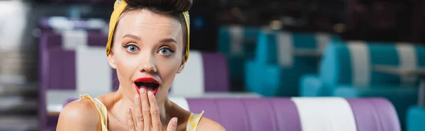 Amazed pin up woman covering mouth, banner — Stock Photo