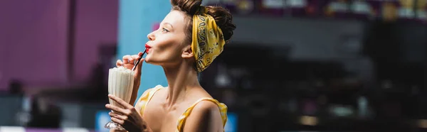 Side view of young pin up woman drinking milkshake, banner — Stock Photo