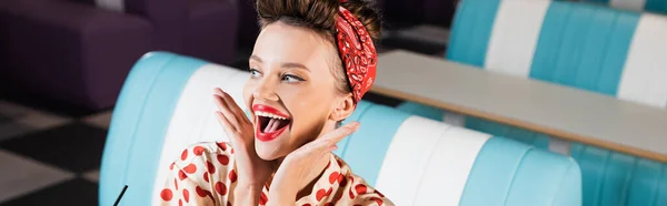 Amazed and young pin up woman in cafe, banner — Stock Photo